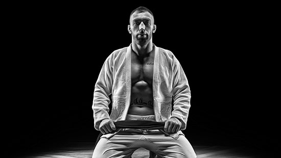 Practitioner using breathwork and meditation before martial arts training